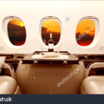 stock-photo-luxury-interior-in-bright-colors-of-genuine-leather-in-the-business-jet-sky-clouds-and-sunset-424966609
