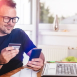 Businessman paying with credit card on smart phone